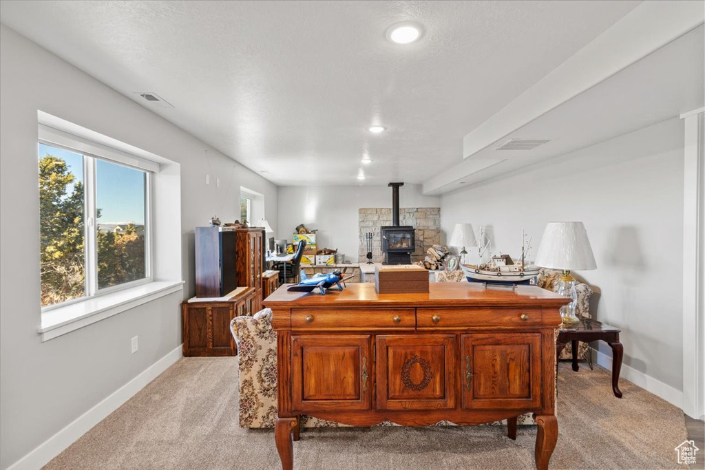 Office with light colored carpet, a wood stove, baseboards, and recessed lighting