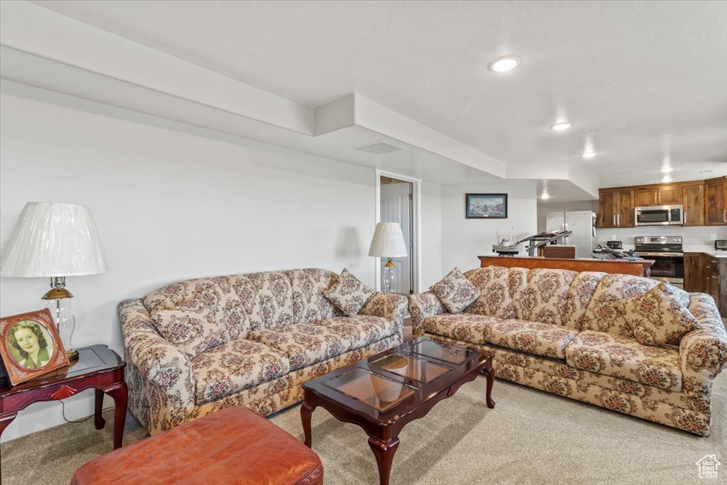 Living room featuring light colored carpet and recessed lighting