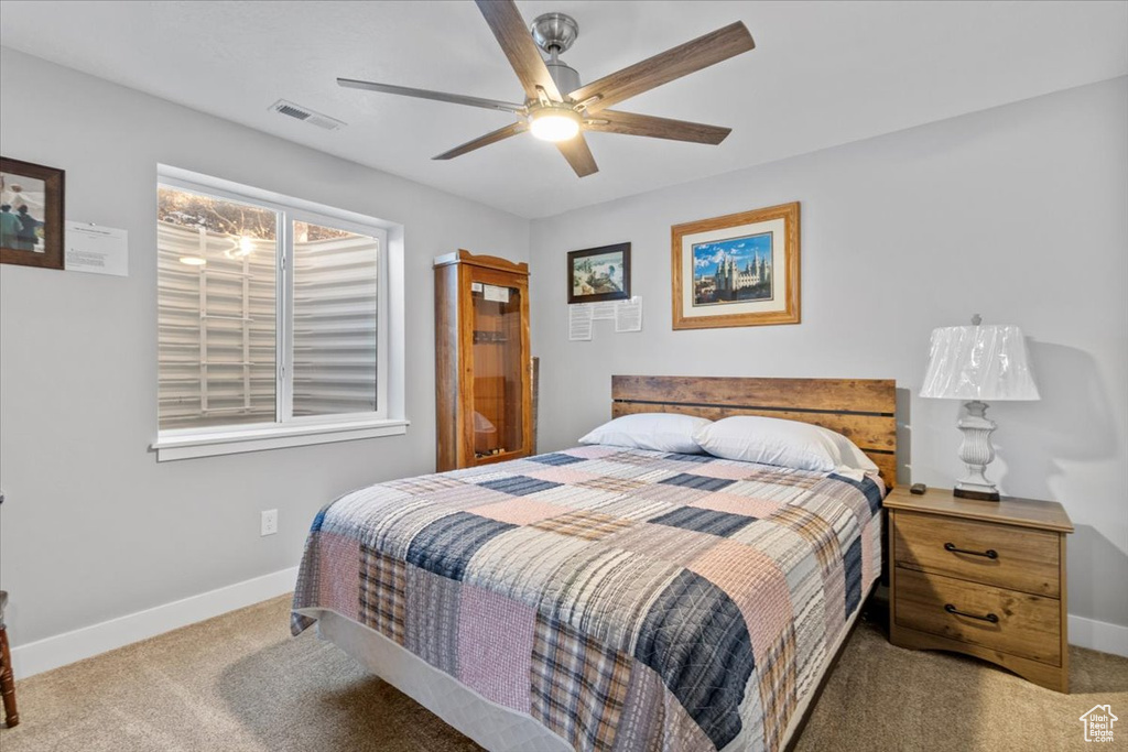 Bedroom with carpet flooring, baseboards, and a ceiling fan