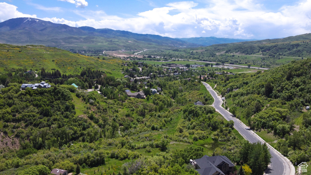 Birds eye view of property featuring a mountain view and a view of trees