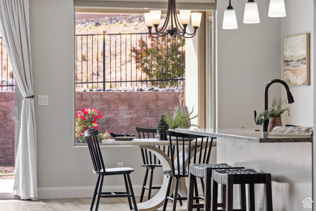 Dining area with a chandelier and baseboards
