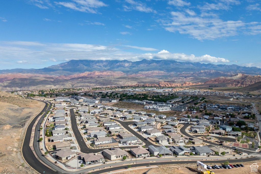 Aerial view of property's location with a mountain backdrop and nearby suburban area