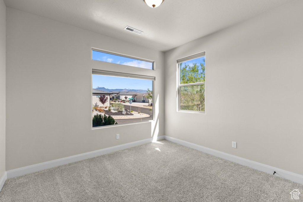 Unfurnished room featuring carpet and baseboards