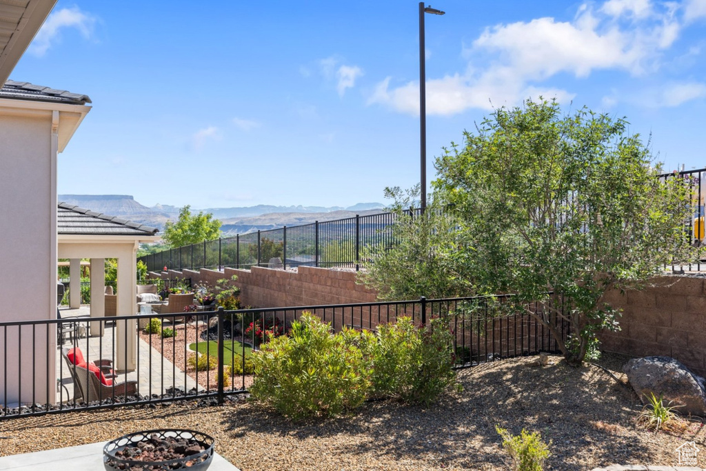Fenced backyard with a mountain view and a patio area