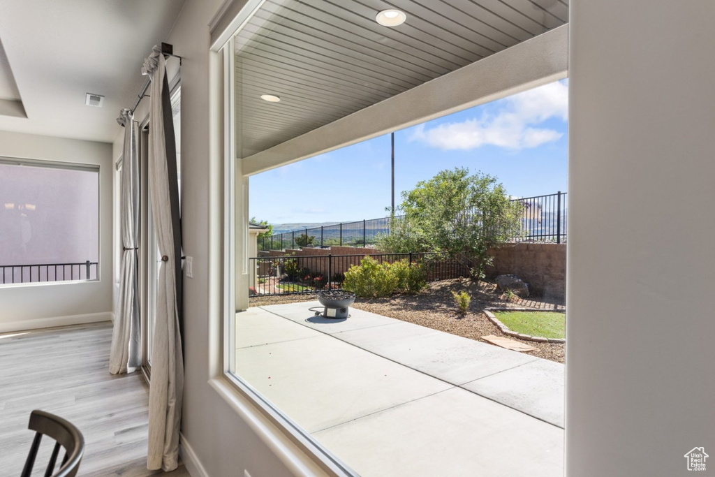 Doorway to outside featuring baseboards and wood finished floors
