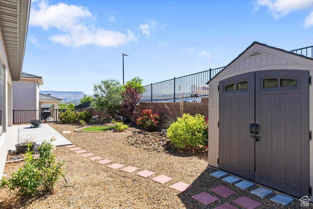 View of shed with a fenced backyard and a mountain view