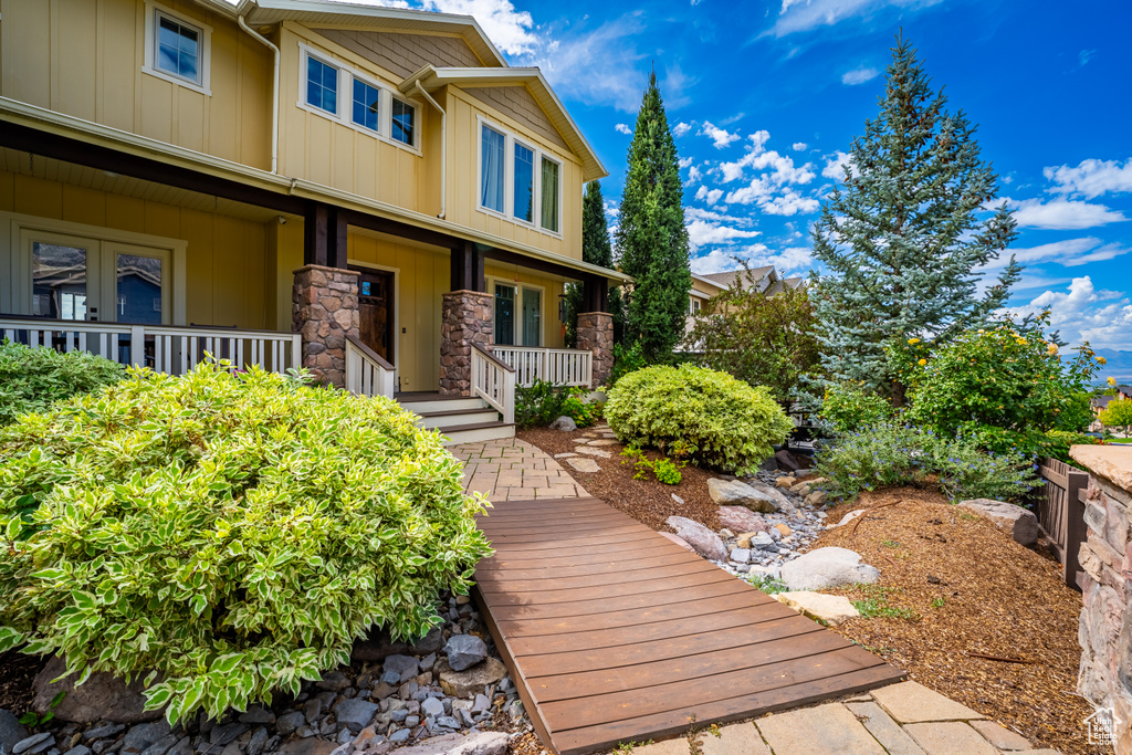Exterior space featuring stone siding, board and batten siding, and a porch