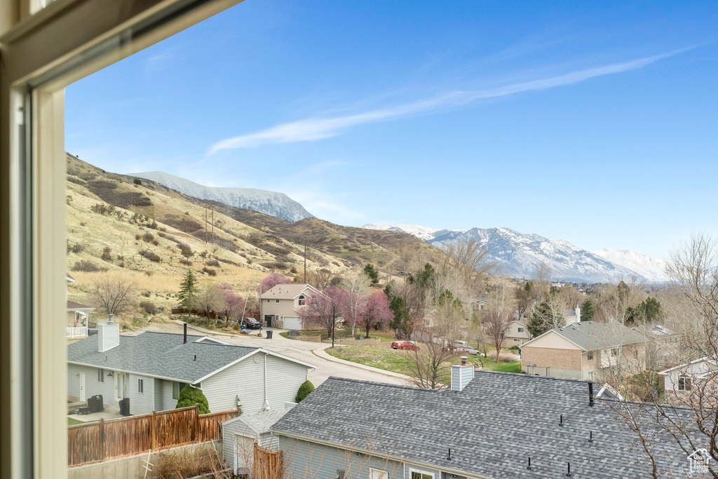 Property view of mountains with a residential view