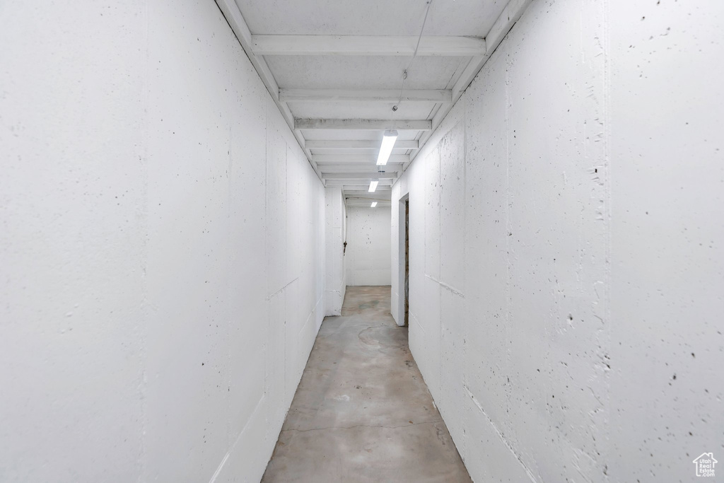 Hallway with unfinished concrete floors