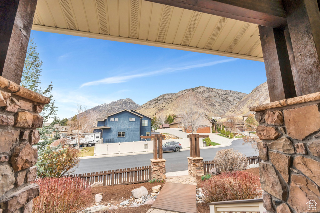 Exterior space with a residential view, a mountain view, and fence