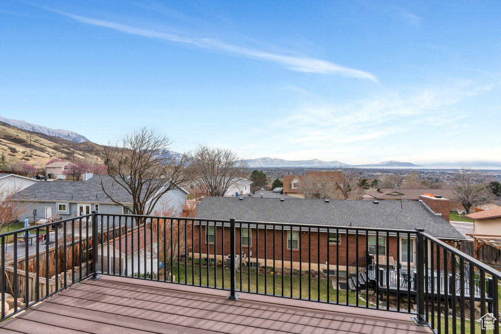 Wooden deck featuring a residential view and a mountain view