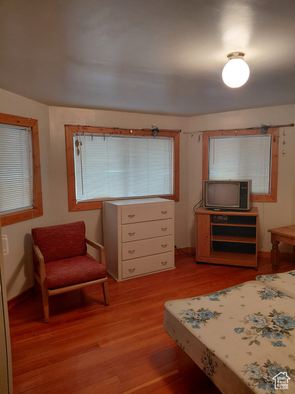 Bedroom with baseboards and light wood finished floors