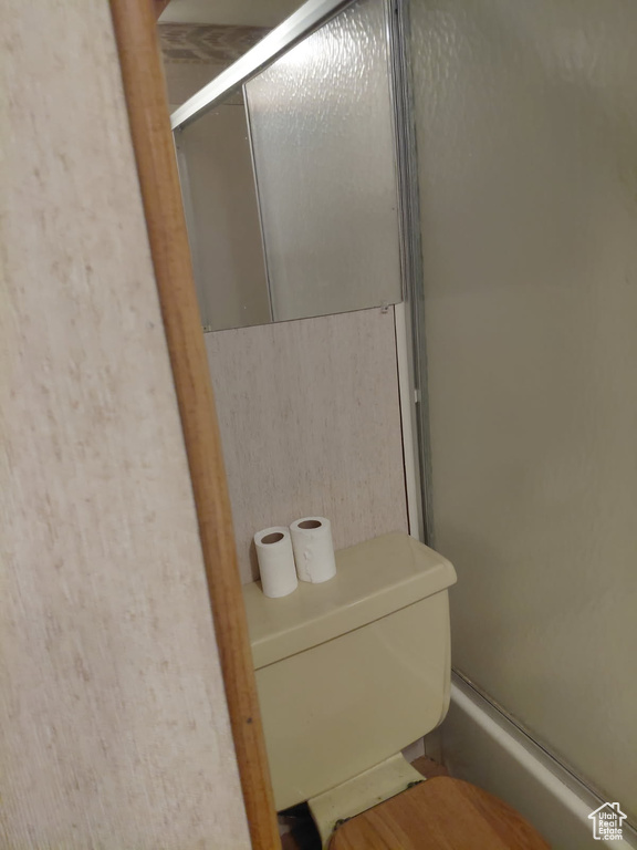 Full bathroom with an enclosed shower and toilet