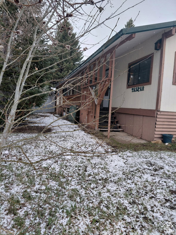 View of snow covered exterior featuring stairway