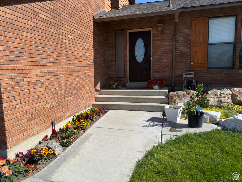 Entrance to property with brick siding