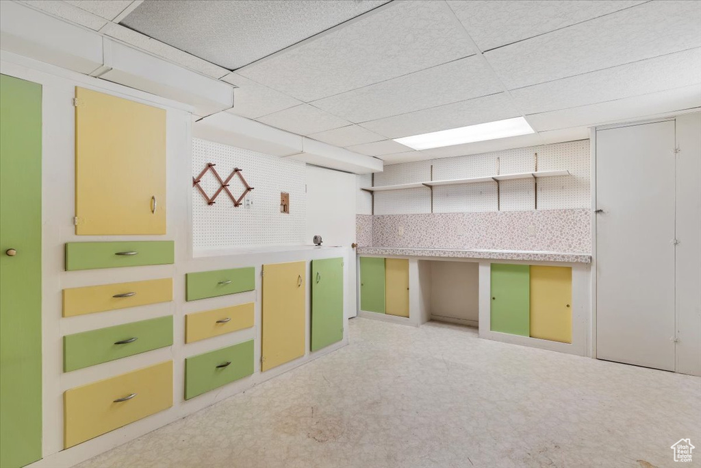 Interior space featuring tile patterned floors and a drop ceiling