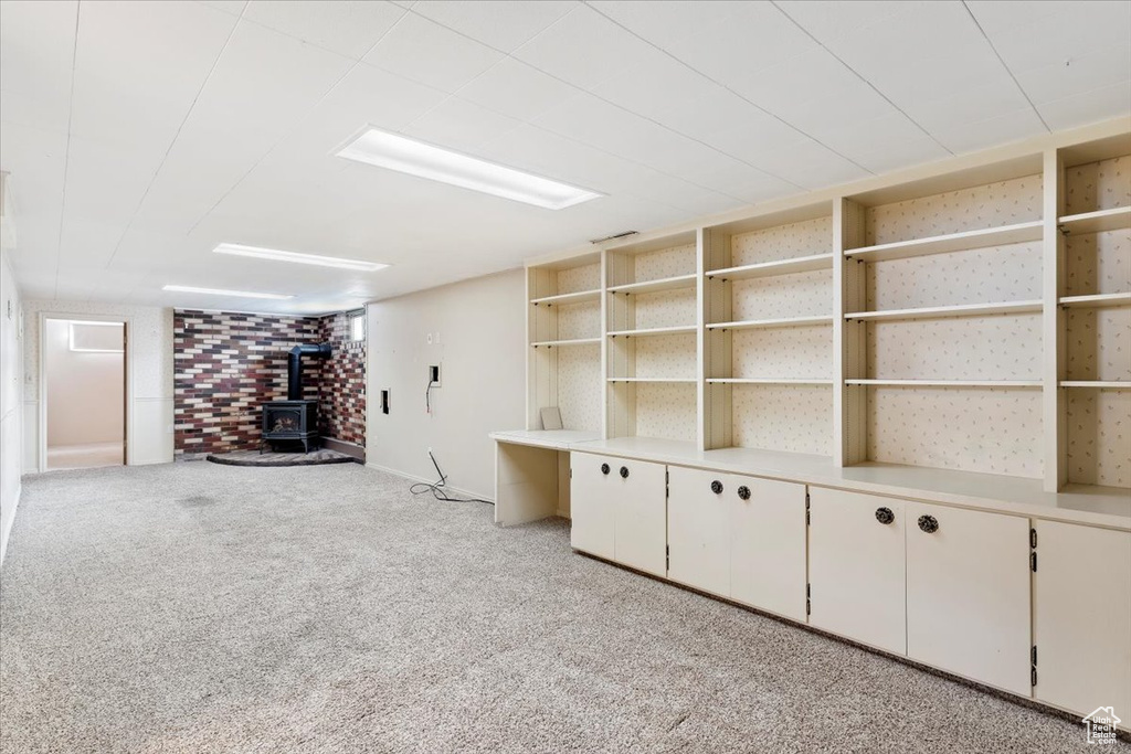 Interior space with light carpet and a wood stove