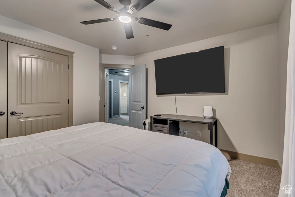 Bedroom with carpet, baseboards, and ceiling fan