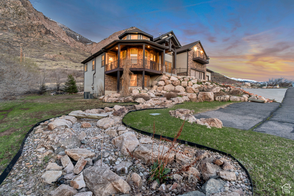Exterior space featuring a balcony and stone siding