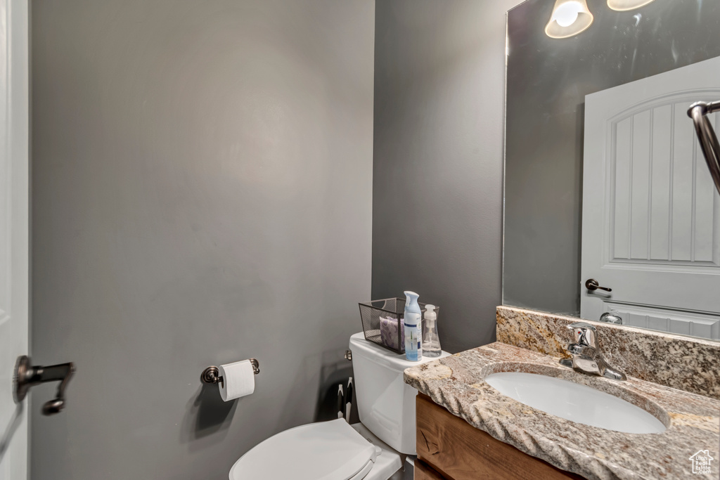 Half bathroom with toilet and vanity