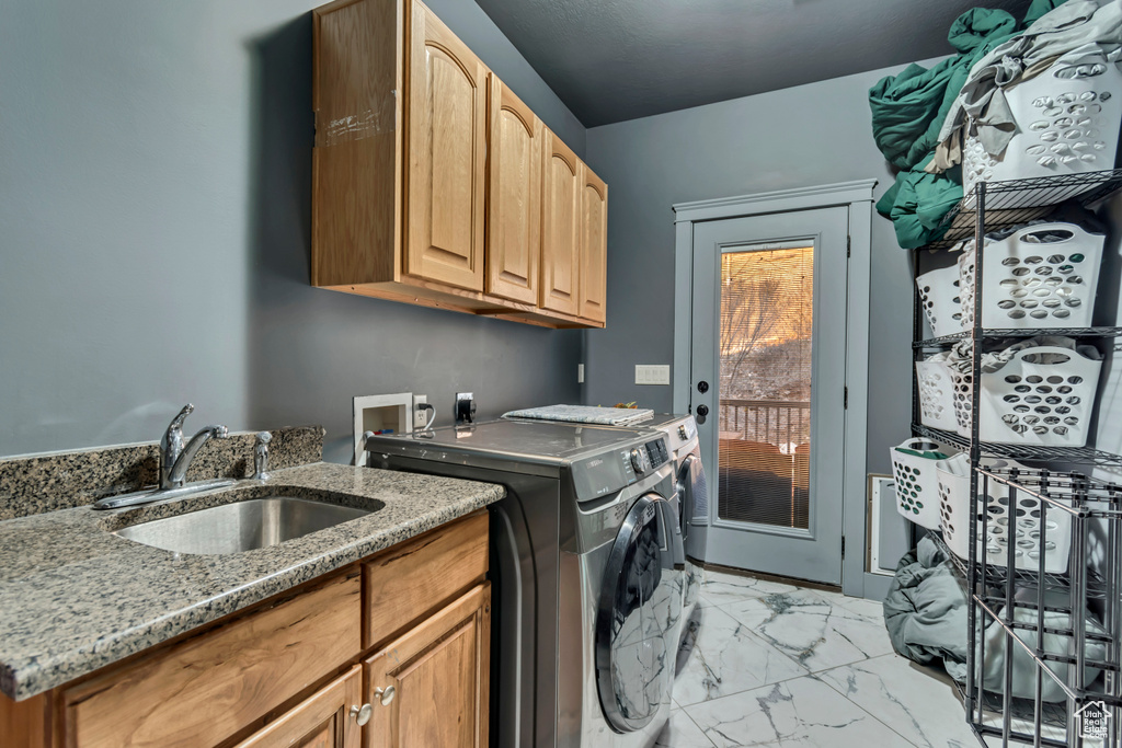 Laundry room with cabinet space, a sink, marble finish floor, and washer and dryer