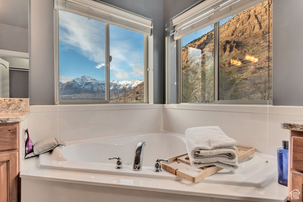 Full bathroom featuring a mountain view, a bath, and vanity