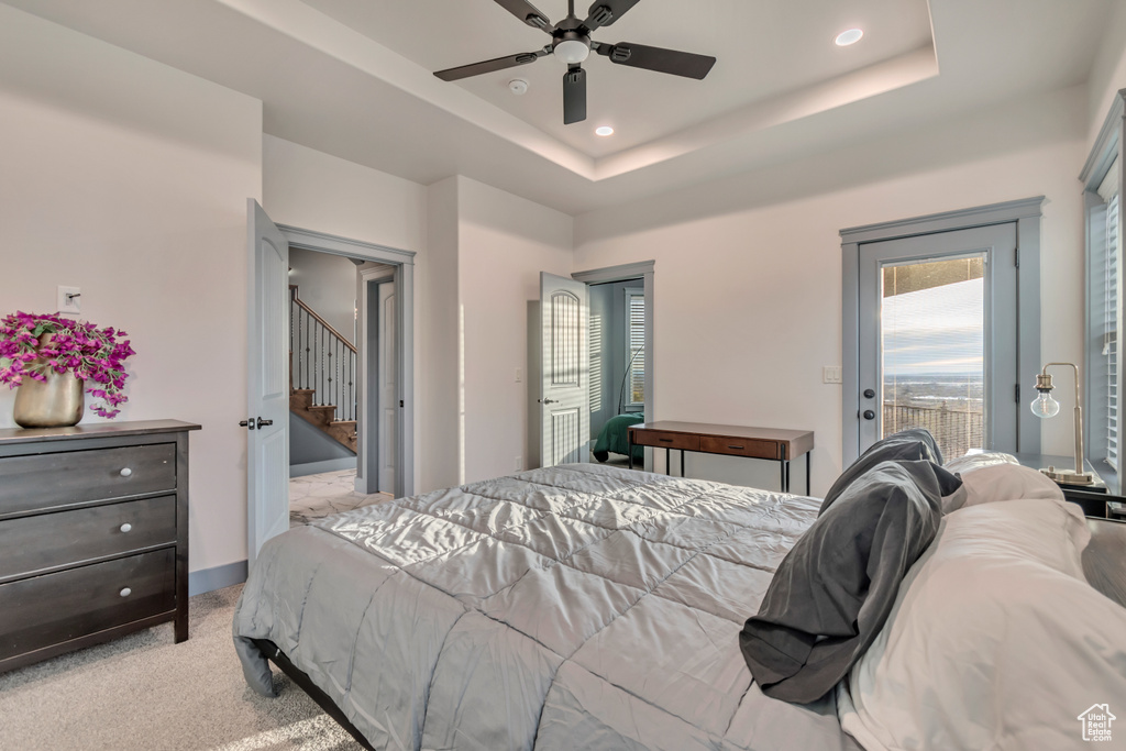Bedroom featuring access to outside, light carpet, recessed lighting, and a raised ceiling