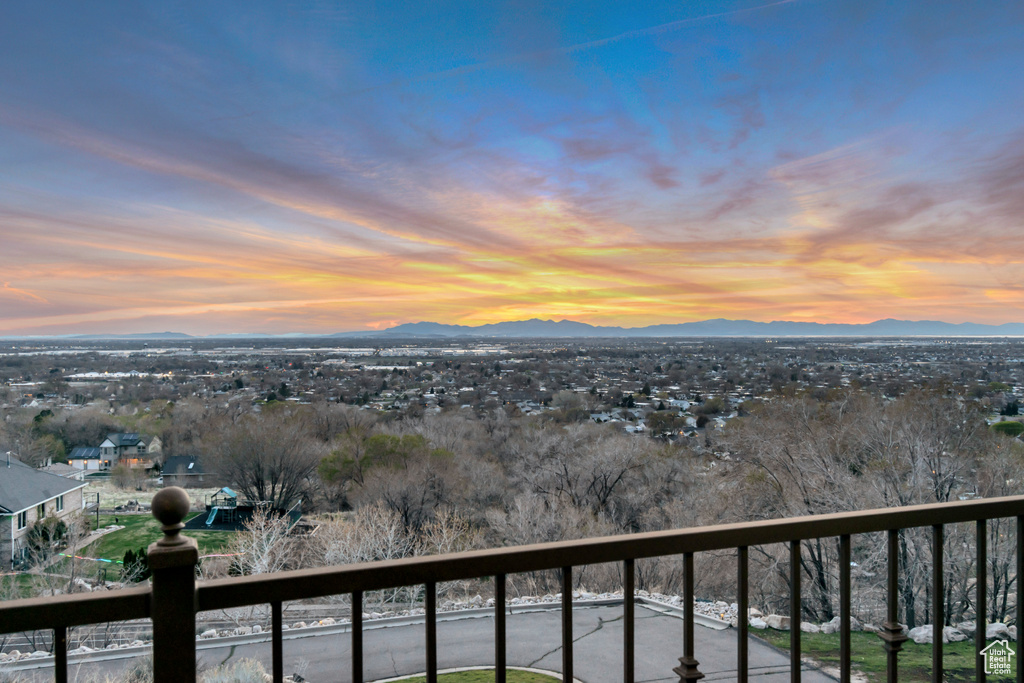 Balcony at dusk featuring a mountain view