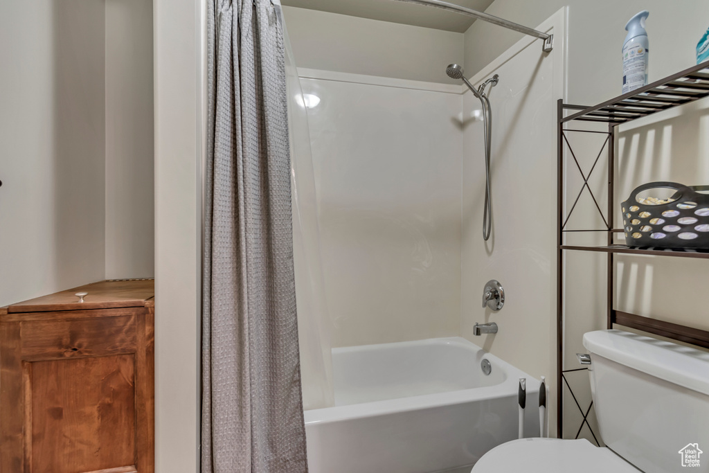 Full bathroom with shower / bath combo and toilet