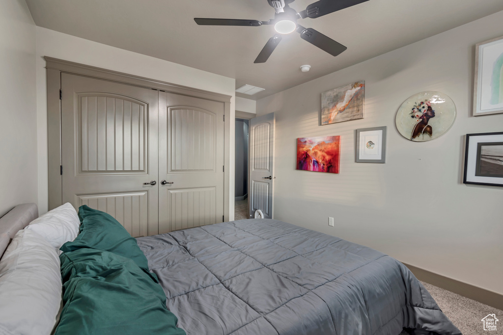 Bedroom with a ceiling fan and a closet
