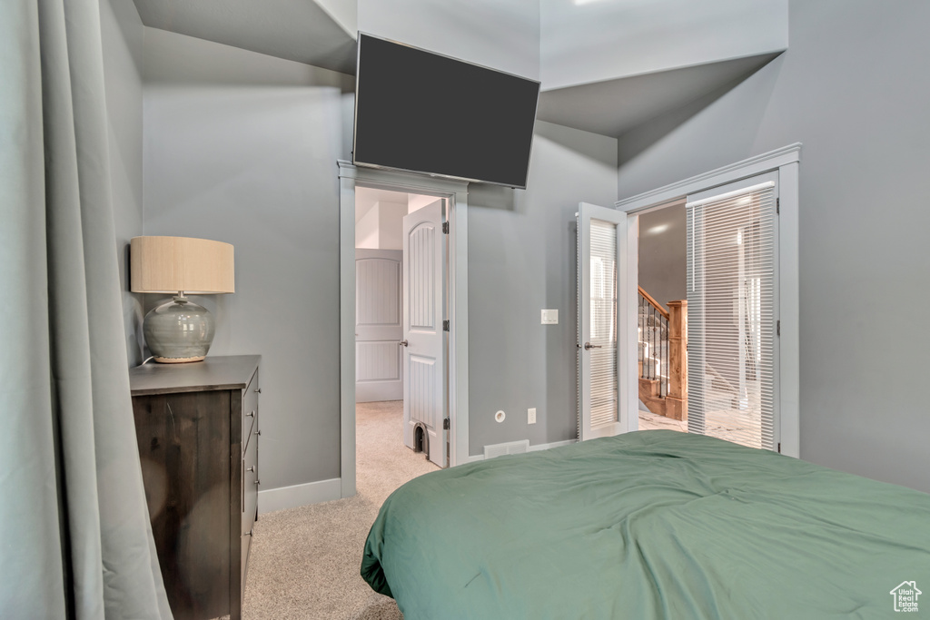 Bedroom featuring light carpet and baseboards