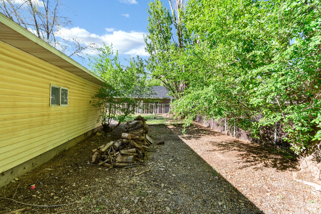 View of yard featuring fence