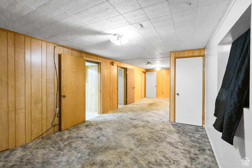 Spare room with carpet floors and wooden walls