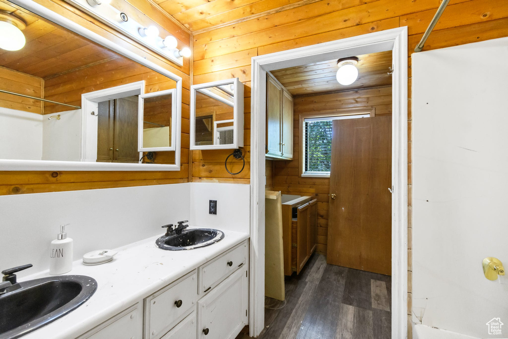 Full bathroom with wood finished floors, wooden ceiling, and double vanity