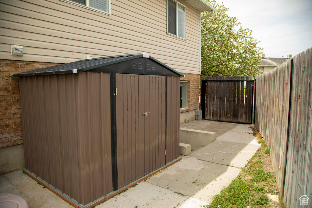 View of shed with a fenced backyard
