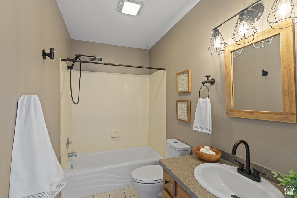 Full bath featuring tile patterned floors, washtub / shower combination, vanity, and toilet