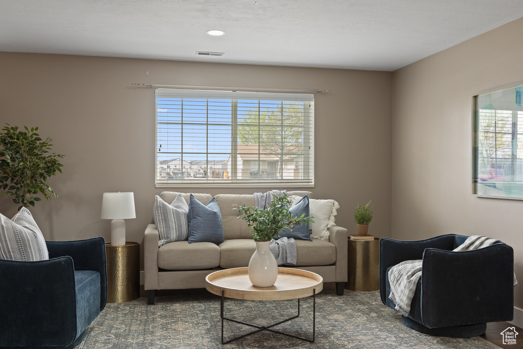 Living area with recessed lighting and visible vents
