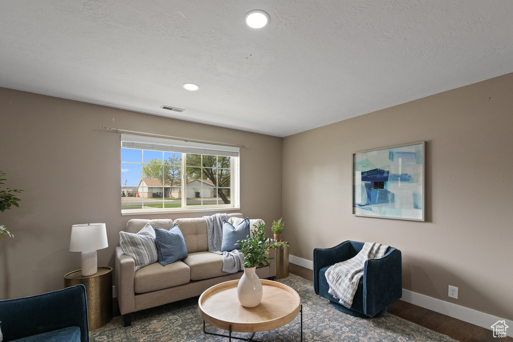 Living room featuring recessed lighting, visible vents, baseboards, and wood finished floors