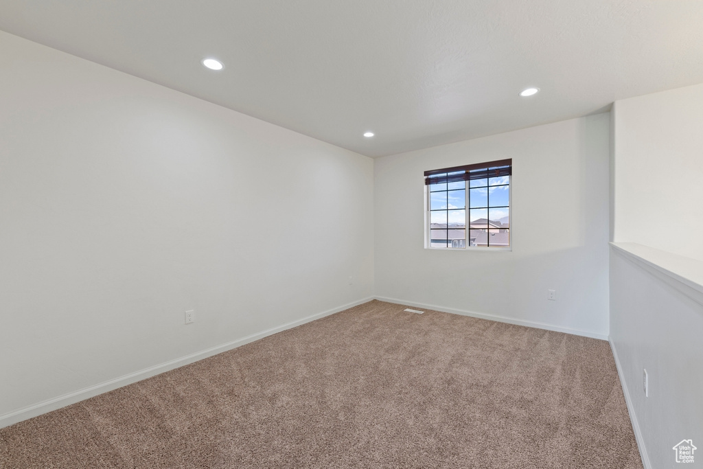 Unfurnished room featuring recessed lighting, baseboards, and carpet