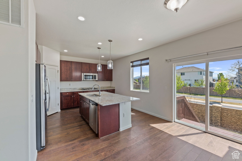 Kitchen with dark wood-style flooring, a sink, stainless steel appliances, recessed lighting, and visible vents