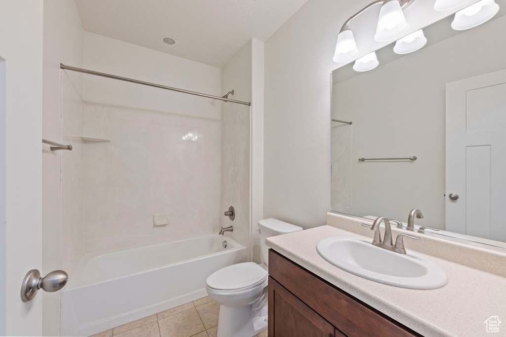 Full bath featuring vanity, shower / tub combination, tile patterned floors, and toilet