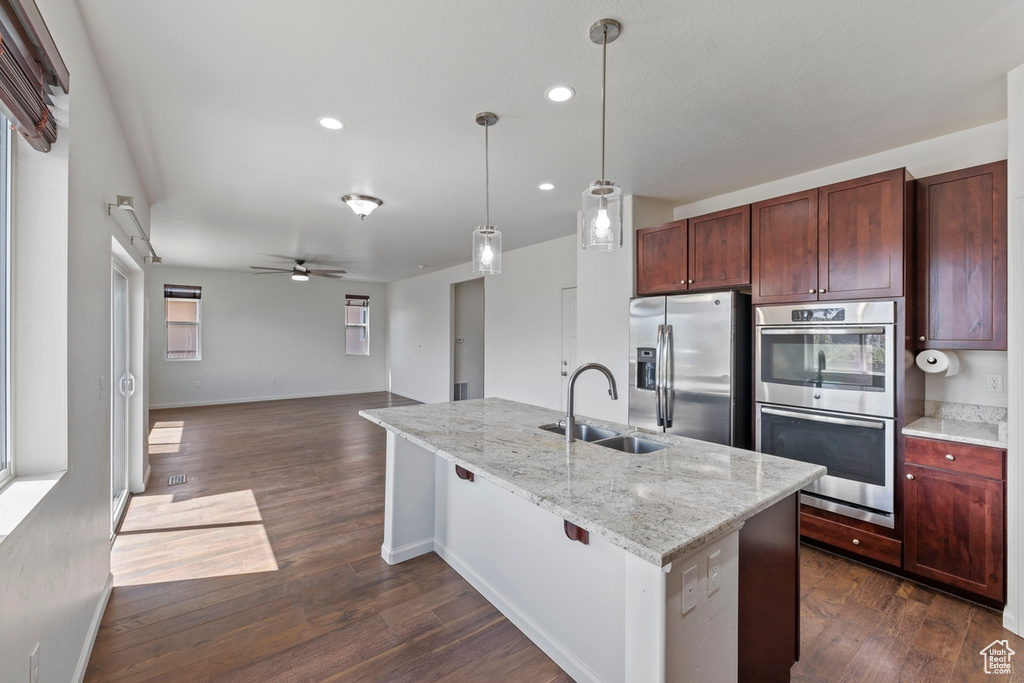 Kitchen with a sink, recessed lighting, a ceiling fan, dark wood finished floors, and appliances with stainless steel finishes