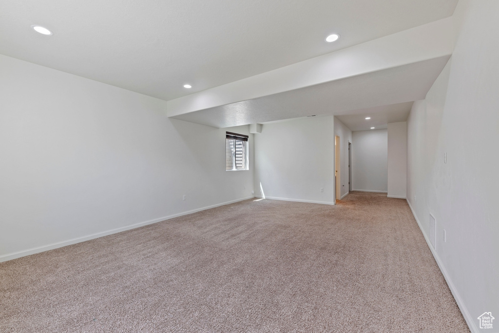 Spare room featuring recessed lighting, baseboards, and light carpet