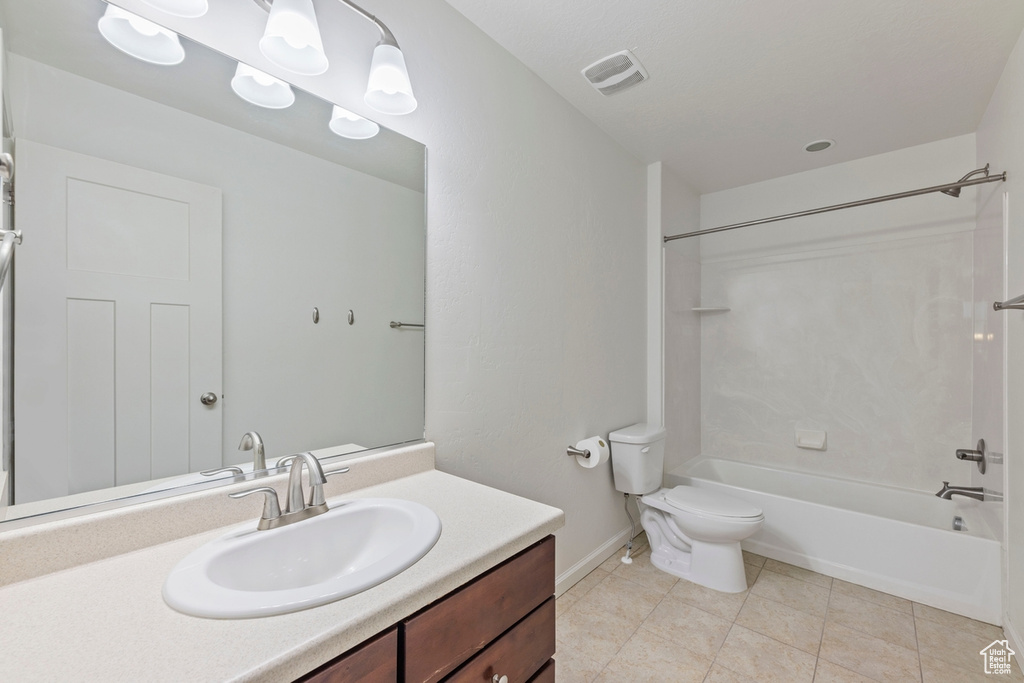 Bathroom with shower / bath combination, tile patterned flooring, vanity, baseboards, and toilet