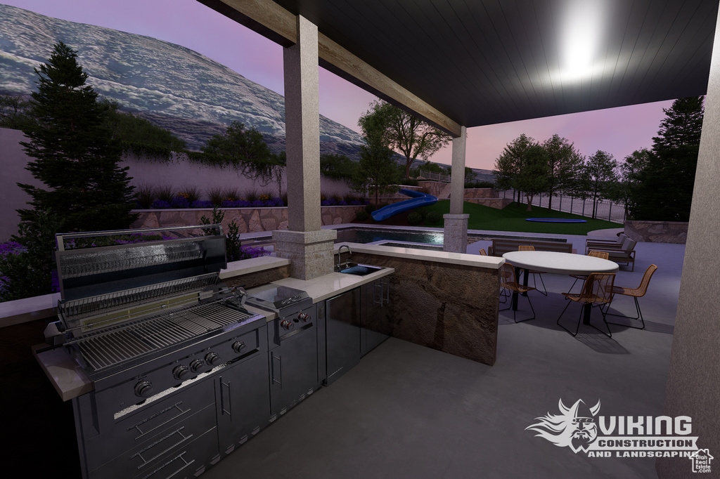 View of patio with area for grilling and a sink