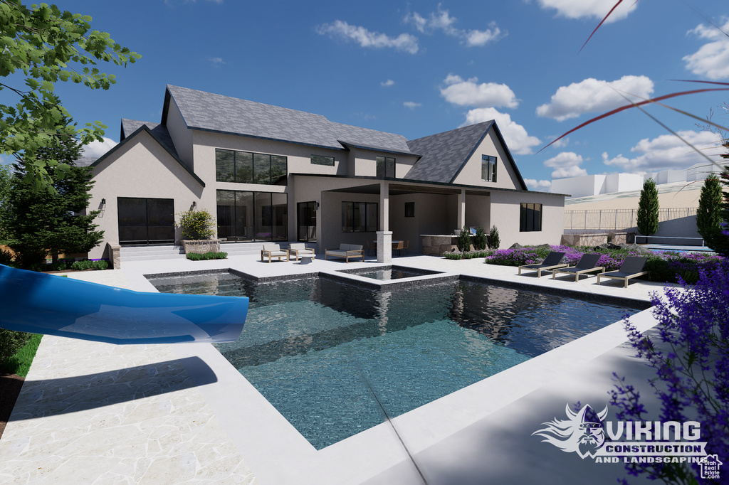 View of swimming pool with a water slide, a pool with connected hot tub, outdoor lounge area, and a patio