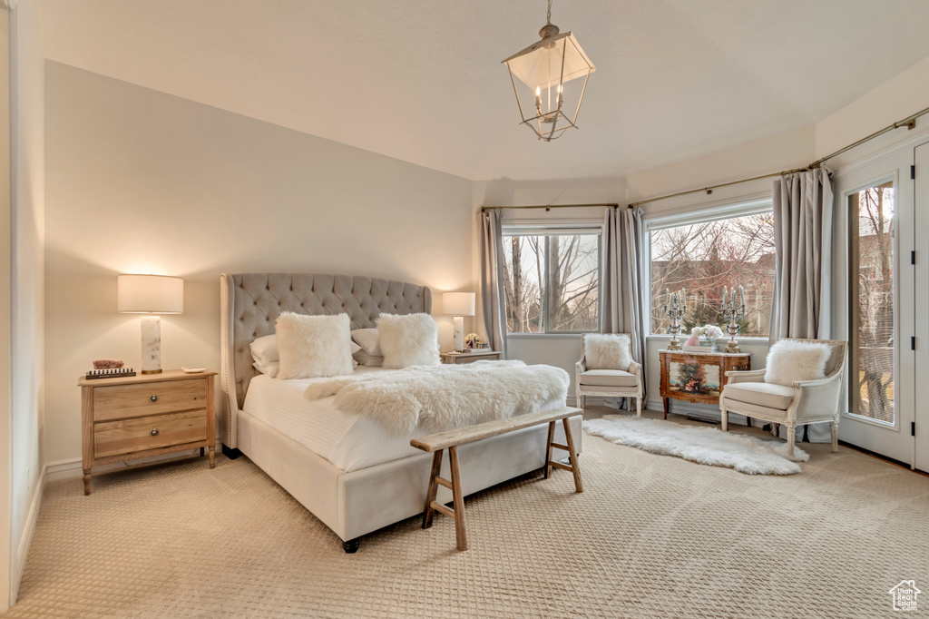 Bedroom featuring multiple windows and carpet floors