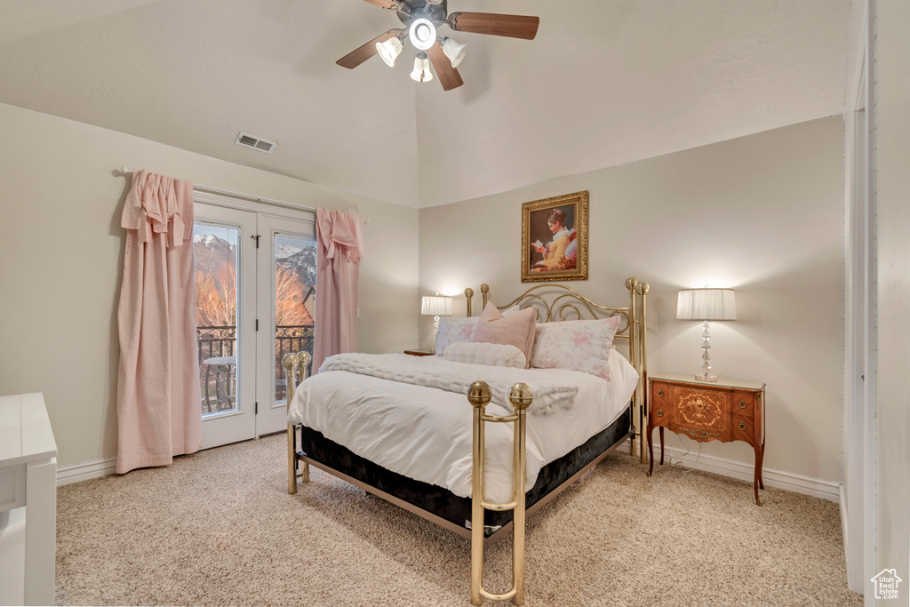 Carpeted bedroom with baseboards, lofted ceiling, access to exterior, and visible vents