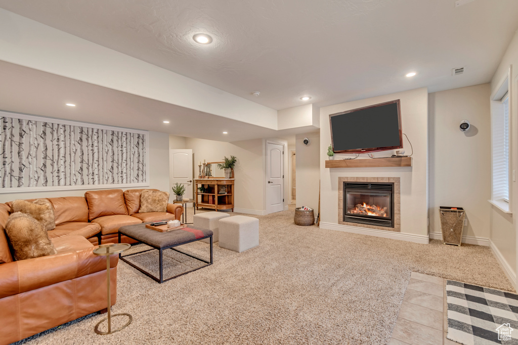 Living room with carpet, baseboards, a fireplace, and recessed lighting