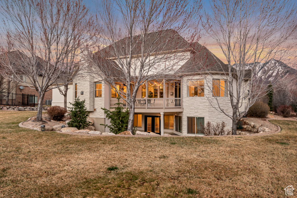 Rear view of house with a yard